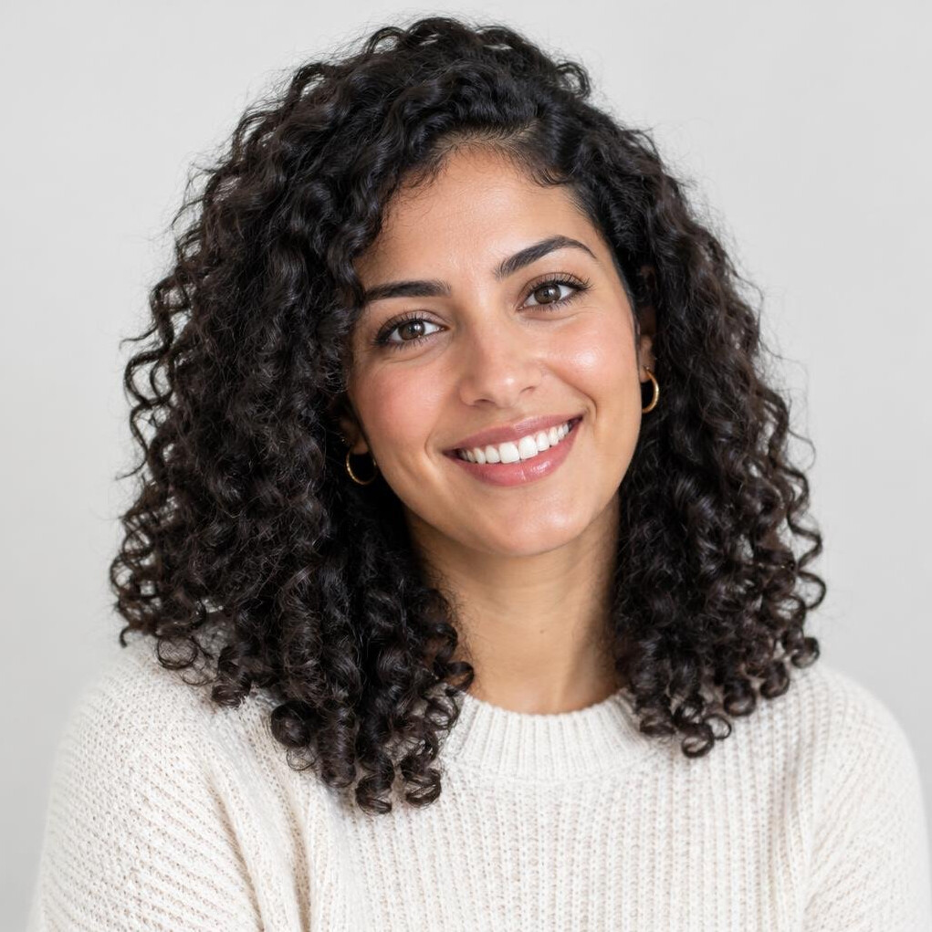 Portrait of a cheerful young woman with dark curly hair